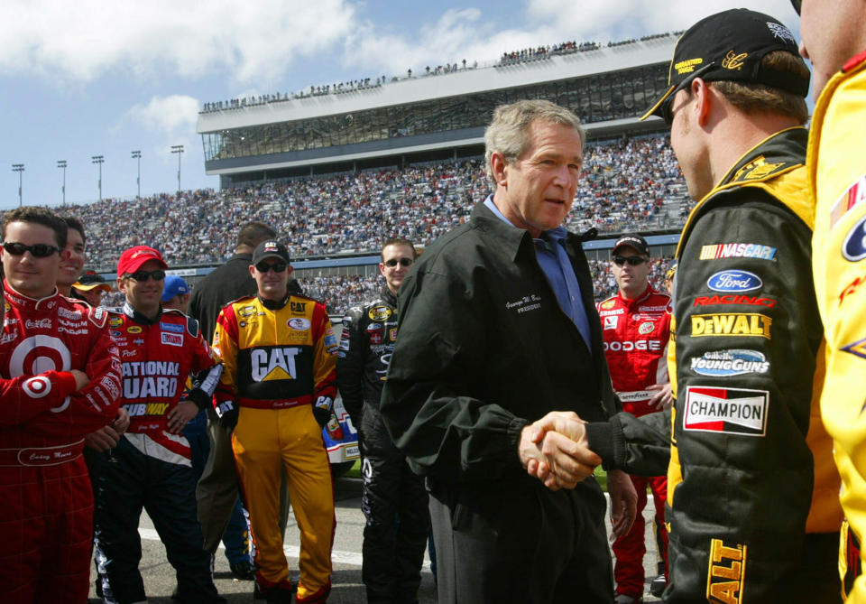 FILE - In this Feb. 15, 2004, file photo, President George W. Bush, left, greets Matt Kenseth, right, as he greets drivers in the pit at Daytona 500 NASCAR race in Daytona Beach, Fla. President Donald Trump will look to rev up his appeal with a key voting demographic Sunday — NASCAR fans — as he takes in the Daytona 500. (AP Photo/Pablo Martinez Monsivais, File)