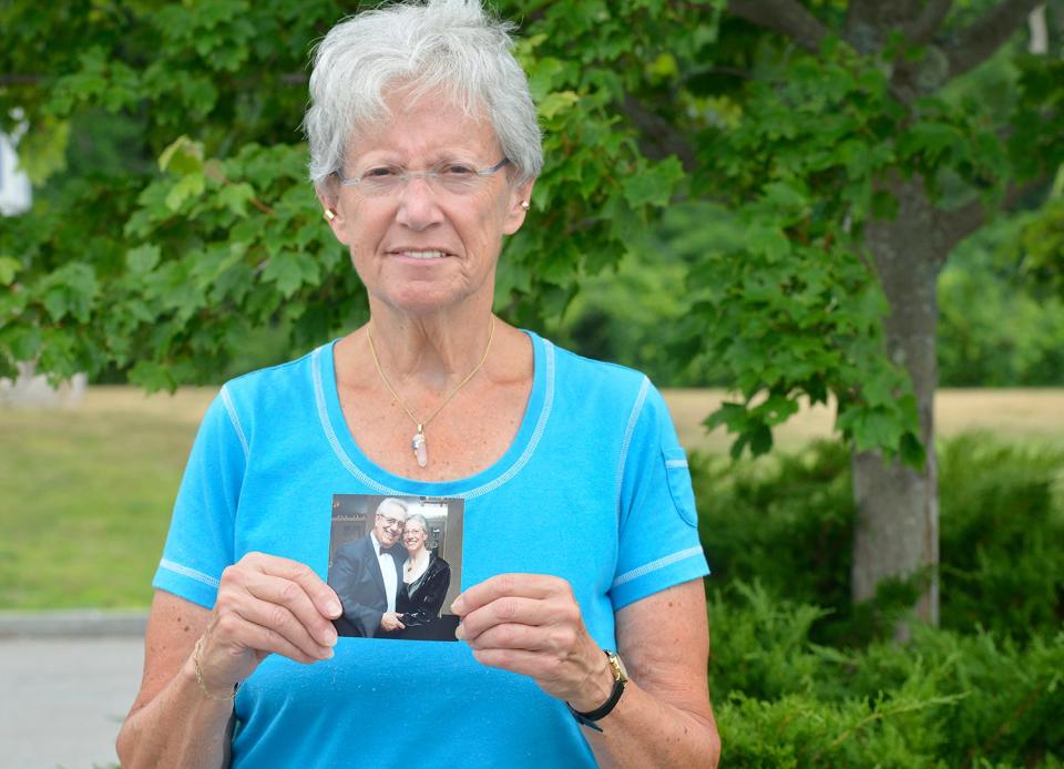 Marlene Samuelson holds a photo of herself with her brother, Stan Samuelson of Mashpee, who died of COVID-19. Stan Samuelson was known for his service to LGBTQ+ plus communities.