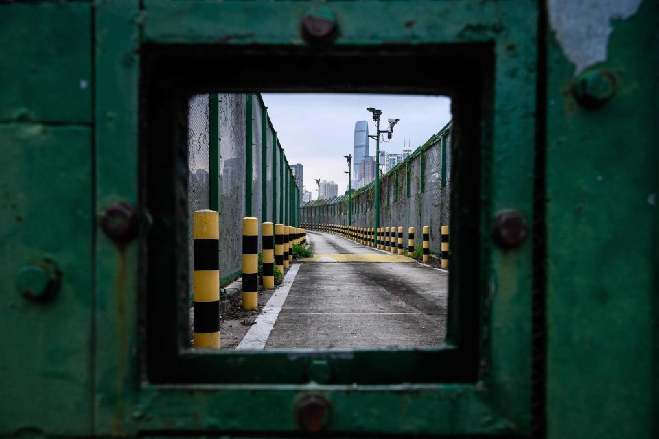 This photo taken in Hong Kong on Feb. 6, 2020, shows the border fence with Shenzhen, China (background), near Lo Wu station. | ANTHONY WALLACE/AFP via Getty Images