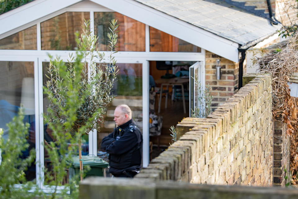 Police investigate the rear part of the Twickenham property. (SWNS)