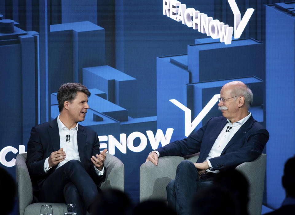 BMW CEO Harald Krueger, left, and Mercedes-Benz CEO Dieter Zetsche of Daimler, right, sit together at a press conference in Berlin, Germany, Friday, Feb. 22, 2019. Automakers Daimler and BMW are formally launching their joint venture in services that make it possible to use their cars without necessarily owning one. (Bernd von Jutrczenka/dpa via AP)