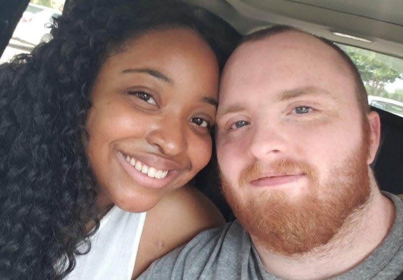 Garrett Foster, right, with his wife, Whitney Mitchell.