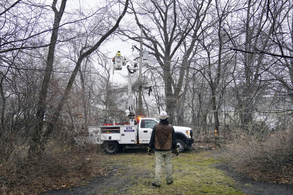 A DTE contractor crew works on a power line, Monday, Feb. 27, 2023, in northwest Detroit. Some Michigan residents faced a fourth straight day without power as crews worked to restore electricity to more than 165,000 homes and businesses in the Detroit area after last week's ice storm. (AP Photo/Carlos Osorio)