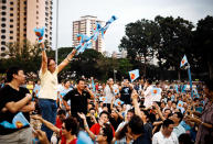 A WP supporter leading the crowd in cheering before the rally starts. Some have been sitting at the Bedok stadium since 3pm. (Yahoo! photo/ Terence Lee)