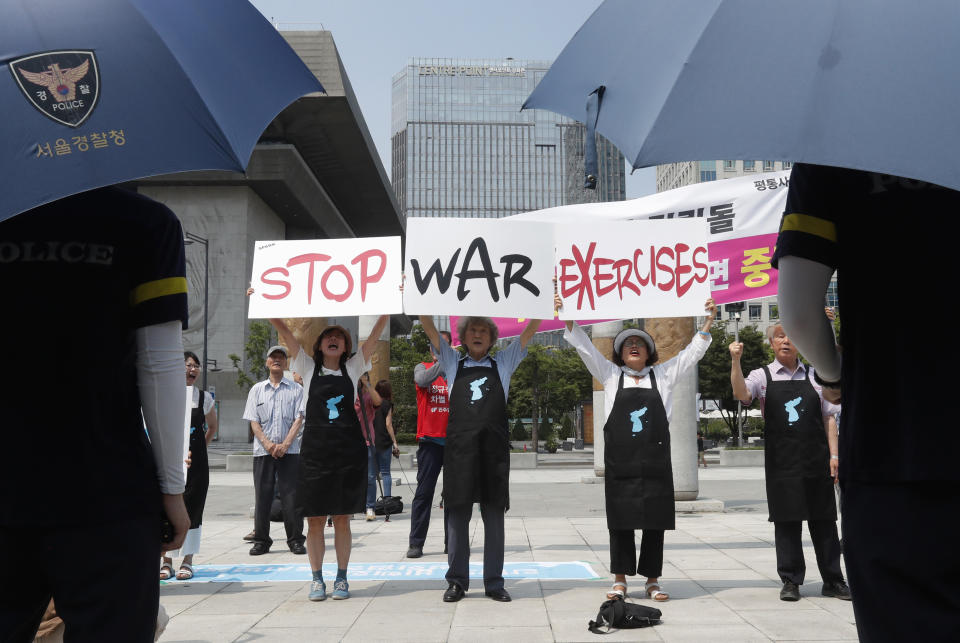 Protesters hold up placards to oppose planned joint military exercises between South Korea and the United States near the U.S. embassy in Seoul, South Korea, Monday, Aug. 5, 2019. The both countries are preparing to hold their annual joint military exercises despite warnings from North Korea that the drills could derail the fragile nuclear diplomacy, Seoul's military said Friday. (AP Photo/Ahn Young-joon)
