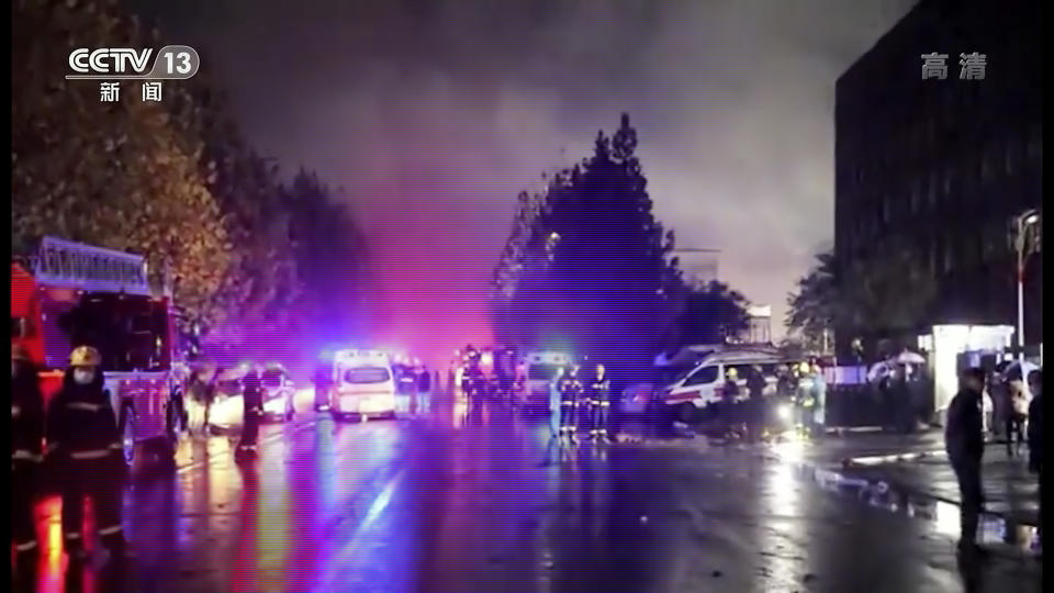 In this image taken from video footage run by China's CCTV, rescuers gather at the site of a fire at an industrial wholesaler in Anyang in central China's Henan province, Monday, Nov. 21, 2022. A fire has killed several dozen people at a company dealing in chemicals and other industrial goods in central China's Henan province. (CCTV via AP)