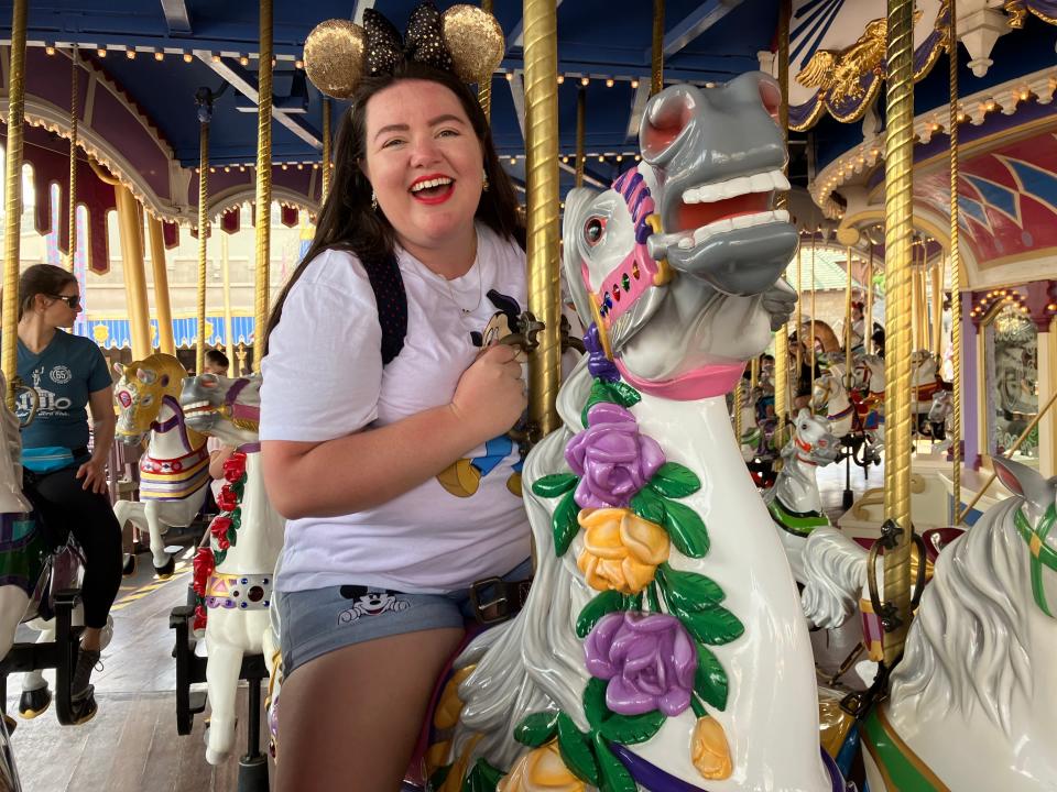 megan riding the carousel at disney world as an adult