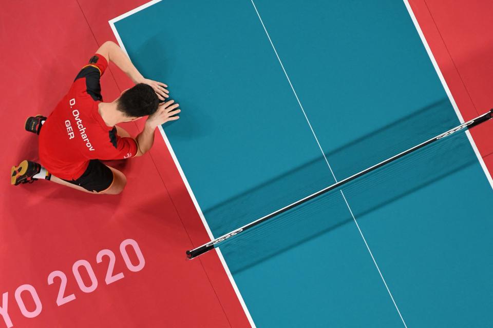 <p>An overview image shows Germany's Dimitrij Ovtcharov reacting after defeating Taiwan's Lin Yun-ju during the men's singles table tennis match for the bronze medal at the Tokyo Metropolitan Gymnasium during the Tokyo 2020 Olympic Games in Tokyo on July 30, 2021. (Photo by Jung Yeon-je / POOL / AFP) (Photo by JUNG YEON-JE/POOL/AFP via Getty Images)</p> 