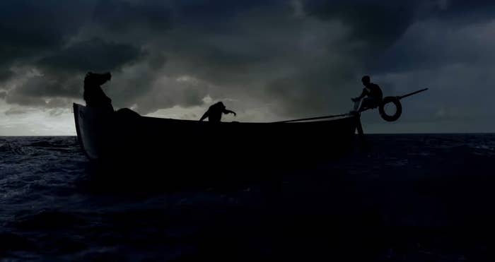 shadowy photo of people in a wood boat out at sea