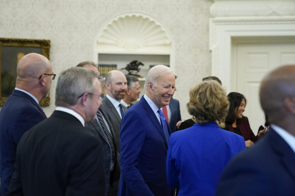 President Joe Biden meets with people in the Oval Office of the White House, Thursday, Sept. 15, 2022, in Washington. Biden said Thursday that a tentative railway labor agreement has been reached, averting a strike that could have been devastating to the economy before the pivotal midterm elections. (AP Photo/Andrew Harnik)