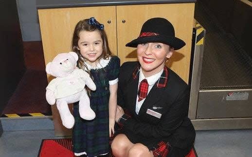 Summer being reunited with Teddy by the cabin crew member, Kirsty Walter, who answered her mother's plea - Twitter/Loganair