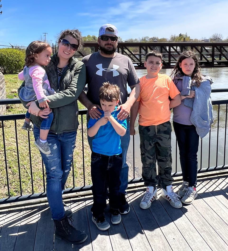Luke Benoit and wife Stephanie Sherman stand with their four children. Benoit went missing from Portsmouth on June 28, and police say the investigation is still active.