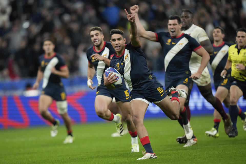 Argentina's Santiago Carreras celebrates as he runs to score a try during the Rugby World Cup third place match between England and Argentina at the Stade de France in Saint-Denis, outside Paris, Friday, Oct. 27, 2023. (AP Photo/Pavel Golovkin)