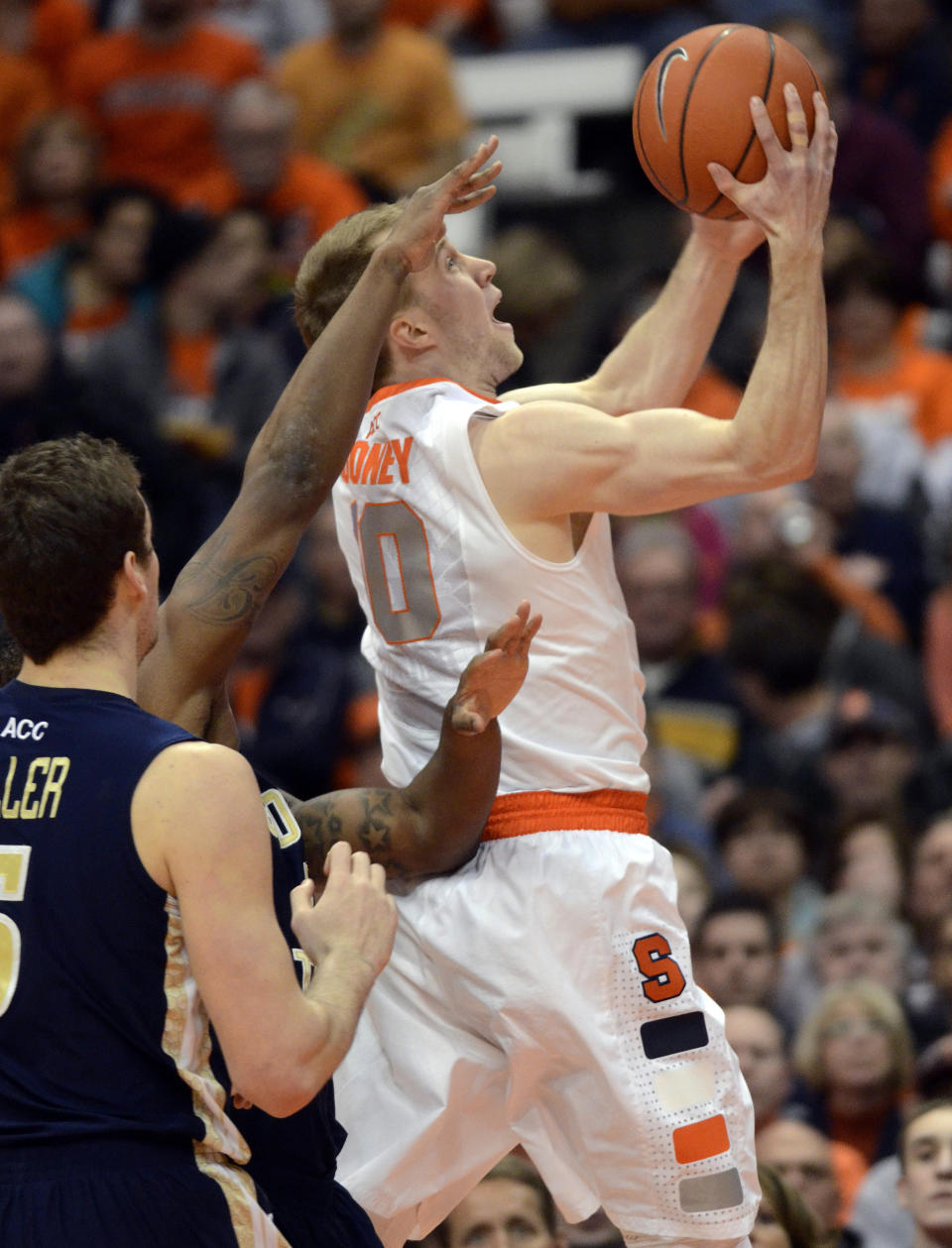 Syracuse's Trevor Cooney drives to the basket against Georgia Tech during the first half of an NCAA college basketball game in Syracuse, N.Y., Tuesday, March 4, 2014. (AP Photo/Kevin Rivoli)