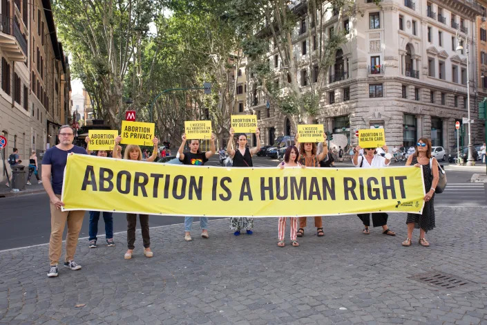 Abortion rights protesters hold up a banner reading: Abortion is a human right.