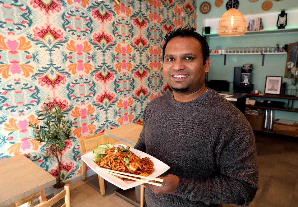 Jeevan Pullan, co-owner of LEMAK Malaysian, holds the Mee Goreng noodle dish at the new restaurant in Scarsdale Jan. 18, 2024.