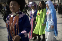 Delegates in ethnic minority dress leave after a meeting one day ahead of the opening session of China's National People's Congress (NPC) at the Great Hall of the People in Beijing, Monday, March 4, 2019. A year since removing any legal barrier to remaining China’s leader for life, Xi Jinping appears firmly in charge, despite a slowing economy, an ongoing trade war with the U.S. and rumbles of discontent over his concentration of power. (AP Photo/Mark Schiefelbein)