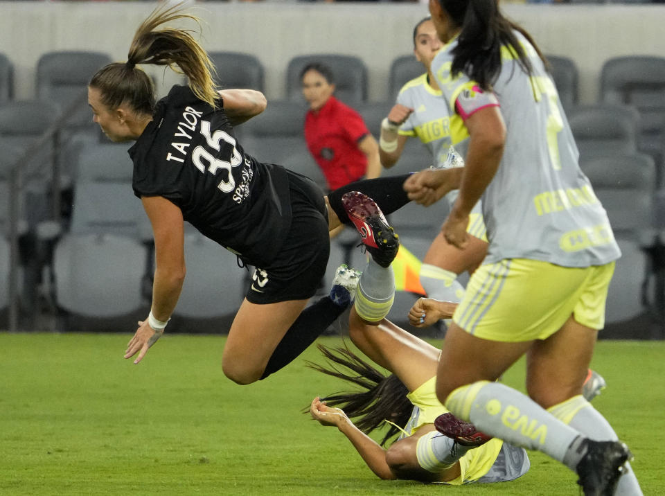 Angel City FC's Miri Taylor (35) falls after a collision with a Tigres UANL player during the first half of a club friendly soccer match in Los Angeles on Wednesday, Aug. 10, 2022. (Keith Birmingham/The Orange County Register via AP)