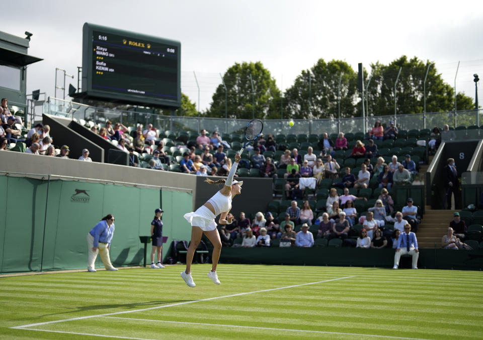 China's Xiyu Wang serves to Sofia Kenin of the US during the women's singles match on day one of the Wimbledon Tennis Championships in London, Monday June 28, 2021. (AP Photo/Alberto Pezzali)