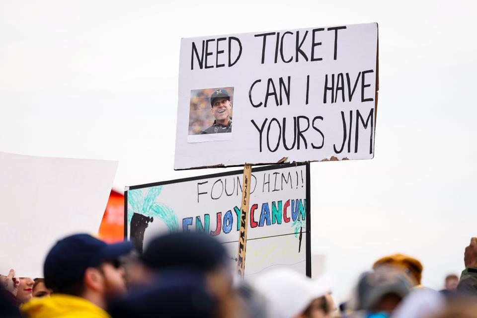 Penn State fans hold signs after the suspension of Michigan head coach Jim Harbaugh before the game at Beaver Stadium on Nov. 11, 2023 in State College, Pennsylvania.
