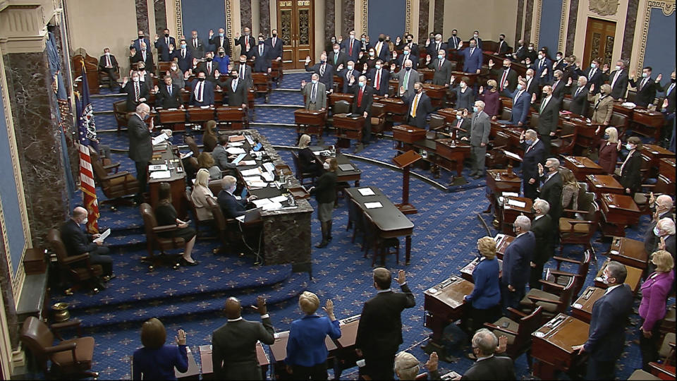 In this Jan. 26, 2021, image from video, Sen. Patrick Leahy, D-Vt., the president pro tempore of the Senate, who is presiding over the impeachment trial of former President Donald Trump, swears in members of the Senate for the impeachment trial at the U.S. Capitol in Washington. (Senate Television via AP)