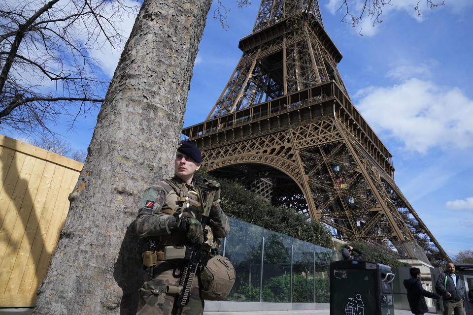 A soldier patrols at the Eiffel Tower, Monday, March 25, 2024 in Paris. France's government increased its security alert posture to the highest level Sunday March 24, 2024 after the deadly attack at a Russian concert hall and the Islamic State's claim of responsibility. (AP Photo/Michel Euler)