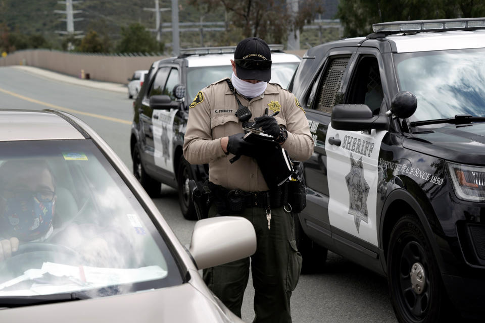 Image: Pueblo Sin Fronteras drive-by protest ICE at Otay Mesa Detention Center (Bing Guan / Reuters)