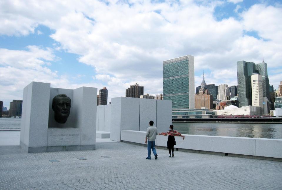 FILE - This May 1, 2014, file photo, shows visitors taking pictures in front of a bust of President Franklin D. Roosevelt at Franklin D. Roosevelt Four Freedoms Park, located on Roosevelt Island in New York. Roosevelt Island will be getting its only hotel, the Graduate Roosevelt Island, in 2019. The Graduate hotel will be located on the gateway of the island's new Cornell Tech campus and will offer skyline views. (AP Photo/Beth J. Harpaz, File)