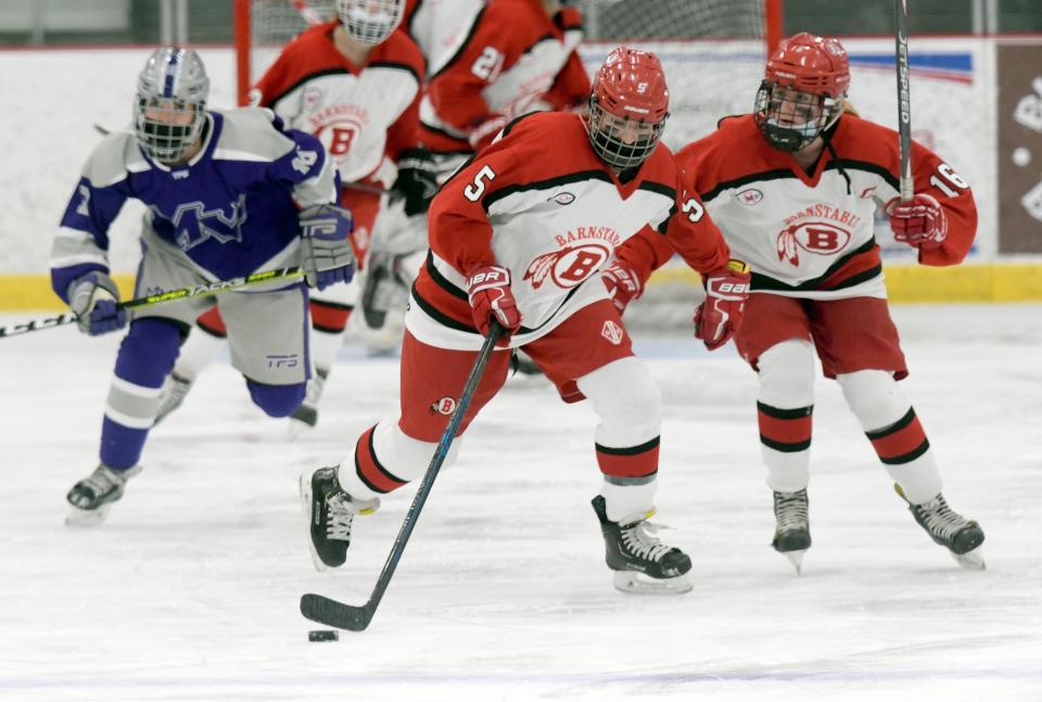 HYANNIS   12/22/21  Avery Braley and Laura Cogswell of Barnstable move the puck ahead of Maia Donnelly of Martha's Vineyard.   girls hockey