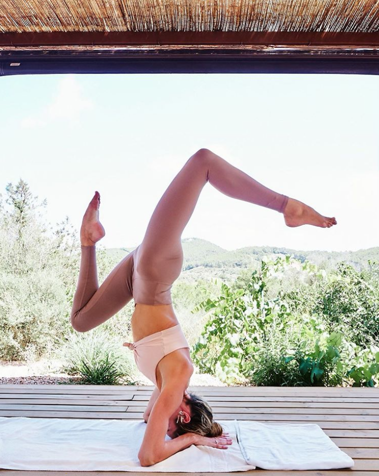 <p>Victoria’s Secret model Candice Swanepoel brings an Insta-worthy variation to a beautiful headstand. Along with yoga, Candice told <a href="https://www.womenshealthmag.com/uk/fitness/a706583/candice-swanepoel-baby-body/" rel="nofollow noopener" target="_blank" data-ylk="slk:Women’s Health in 2017" class="link "><em>Women’s Health</em> in 2017</a> that she likes weight training as well.</p>