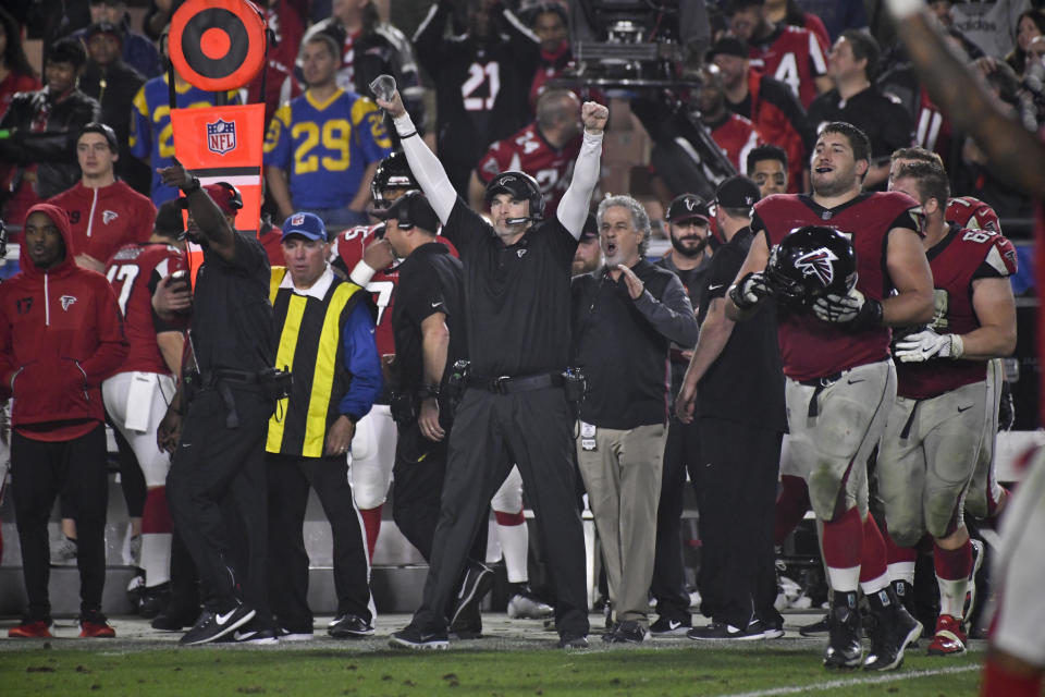 Atlanta Falcons head coach Dan Quinn celebrates after the Falcons’ 26-13 wild-card road win in Los Angeles. (AP)