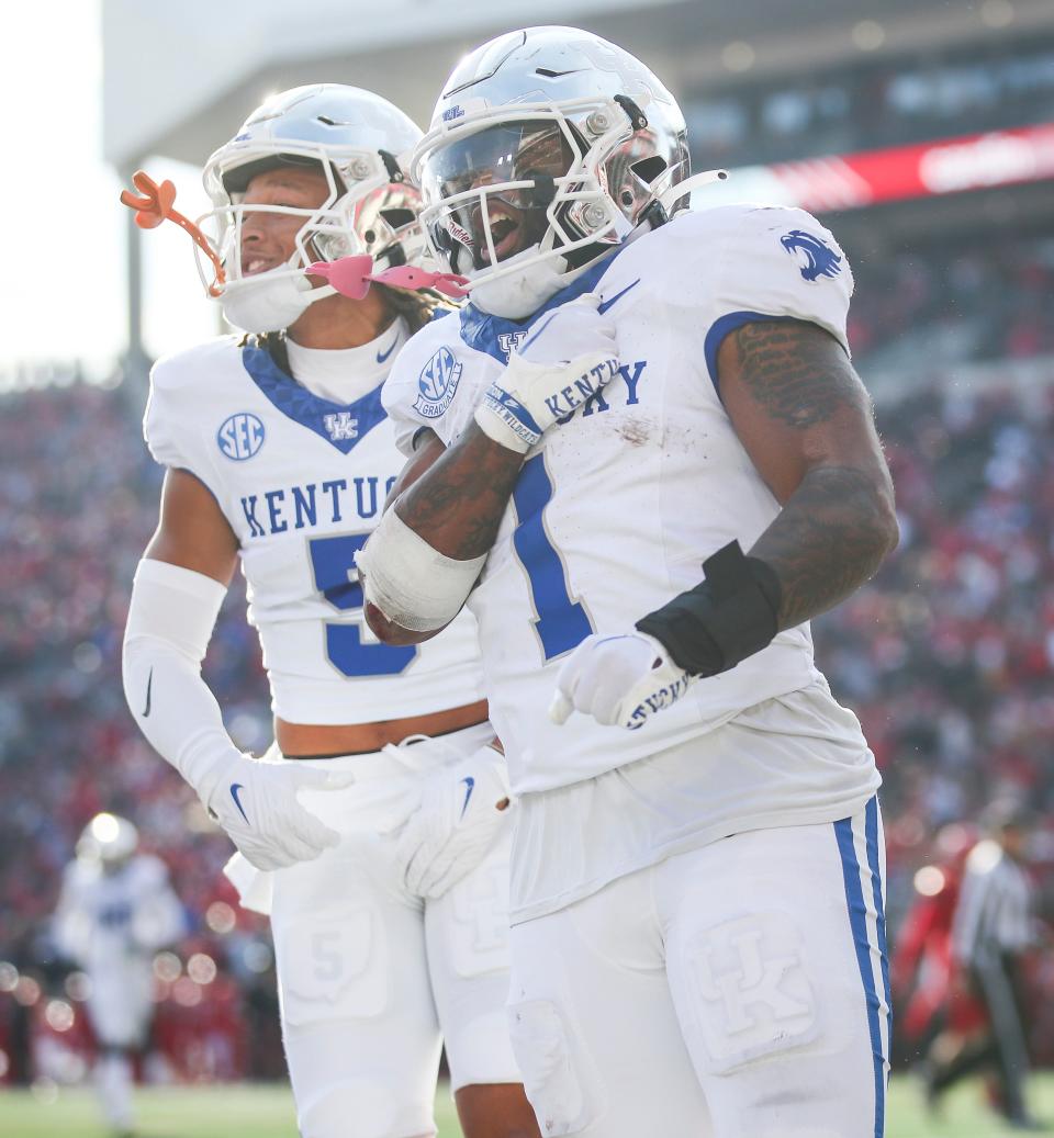 As Kentucky Wildcats wide receiver Anthony Brown-Stephens (5) cheers, Kentucky Wildcats running back Ray Davis (1) celebrates after scoring the go-ahead touchdown the Wildcats beat Louisville 38-31 Saturday and retaining the Governor's Cup. Nov. 24, 2023