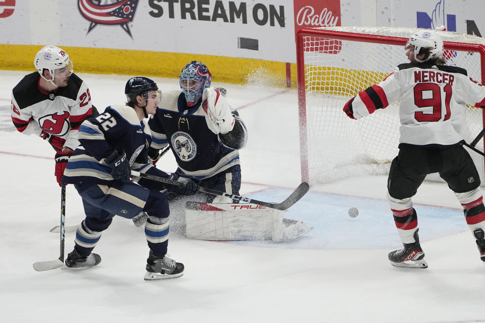 New Jersey Devils right wing Timo Meier, left, scores past Columbus Blue Jackets goaltender Elvis Merzlikins (90) and defenseman Jake Bean (22) as Devils' Lawson Mercer (91) watches during the second period of an NHL hockey game Friday, Jan. 19, 2024, in Columbus, Ohio. (AP Photo/Sue Ogrocki)