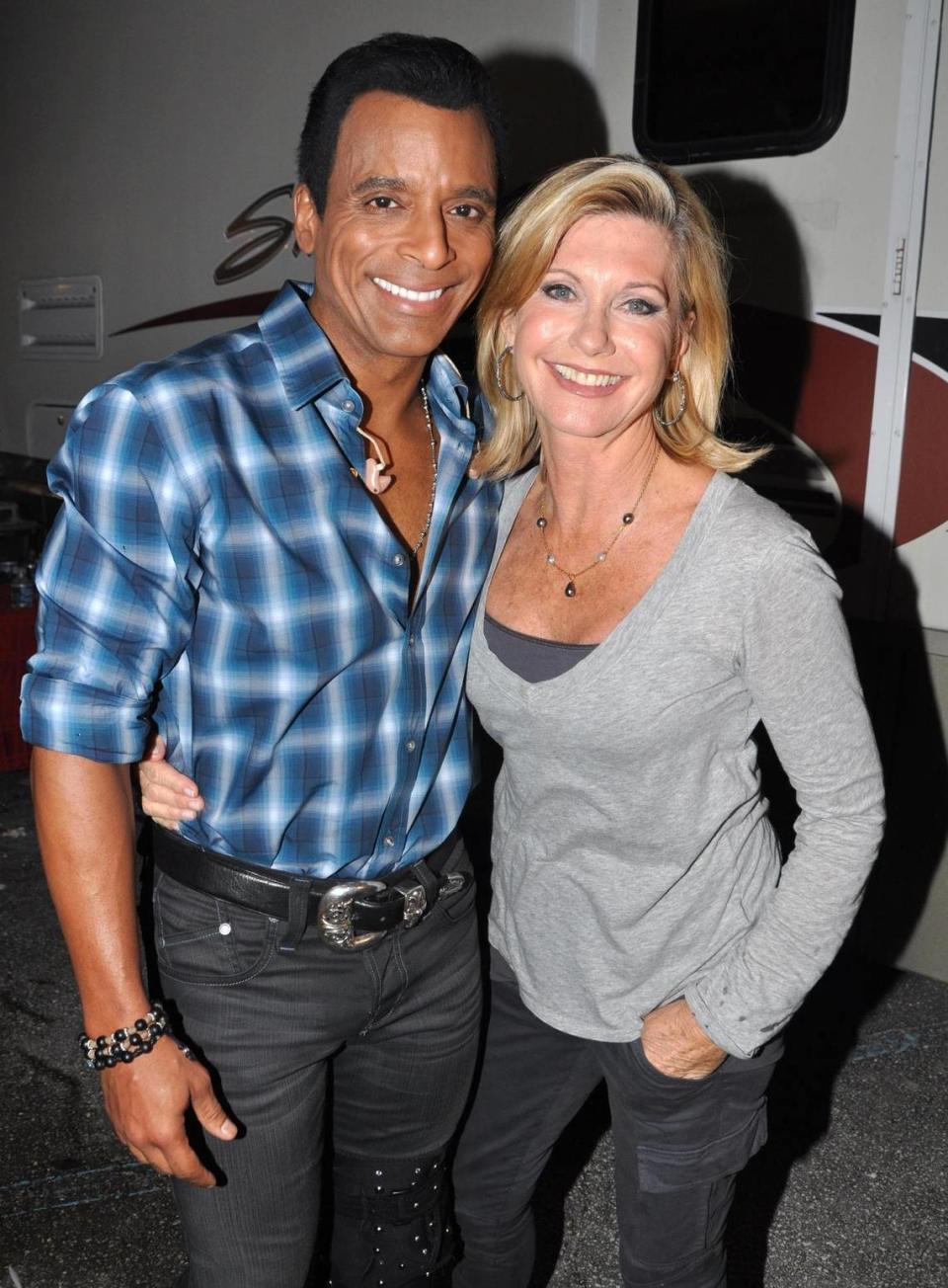 In this file photo from Nov. 5, 2010, Jon Secada and Olivia Newton-John are at the opening of Secada’s lounge at Miami’s Magic City Casino.