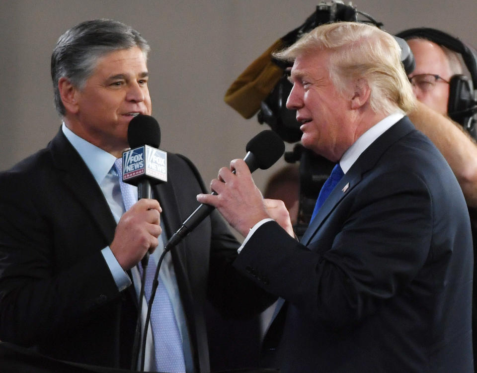 Fox News Channel and radio talk show host Sean Hannity interviews Trump before a campaign rally in 2018. Hannity has sycophantically defended Trump throughout the pandemic. (Photo: Ethan Miller via Getty Images)