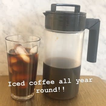 The cold brew coffee maker with coffee in a clear glass with the phrase 