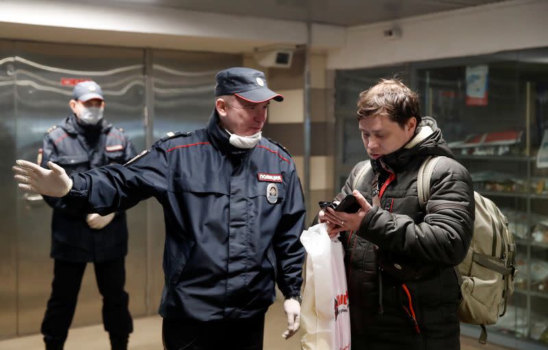 Police officers check pedestrians' documents in Moscow