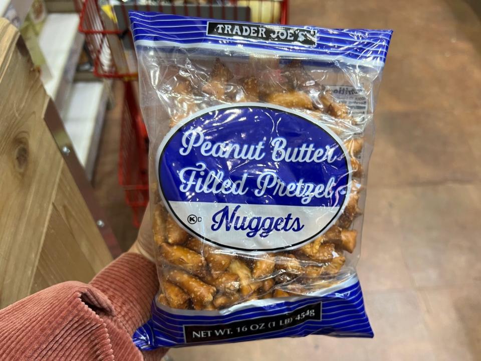 The writer holds a bag of Trader Joe's peanut-butter-filled prestzels