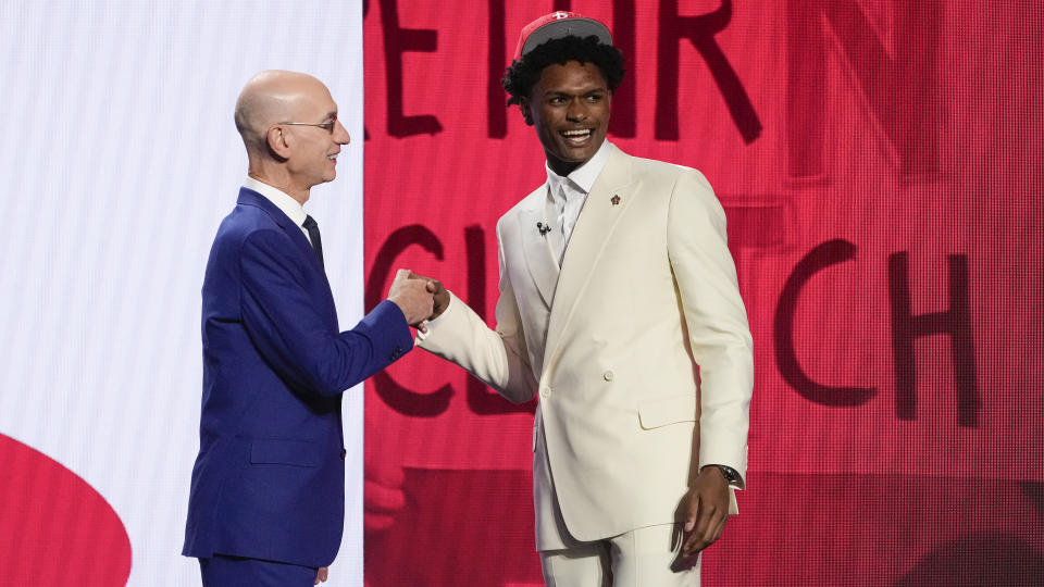 Amen Thompson poses for a photo with NBA Commissioner Adam Silver after being selected fourth overall by the Houston Rockets during the NBA basketball draft, Thursday, June 22, 2023, in New York. (AP Photo/John Minchillo)