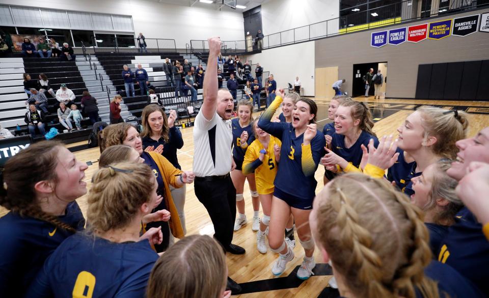Pewamo-Westphalia players and coach Jon Thelen celebrate after defeating Monroe St. Mary Catholic Central, Tuesday, Nov. 15, 2022, at Dansville High School.