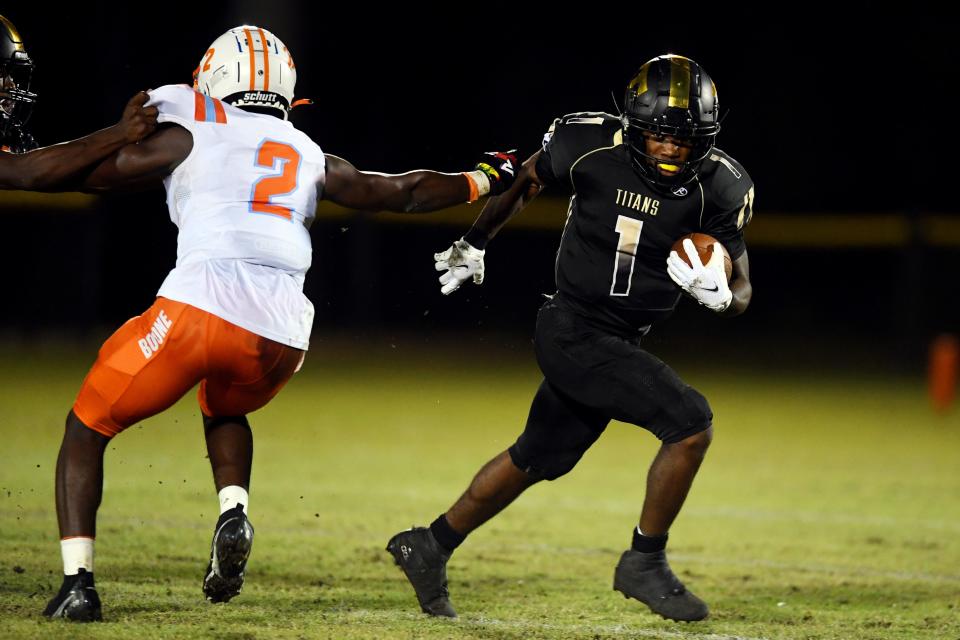 Treasure Coast High School running back Eden James moves the ball up the field on Friday, Nov. 19, 2021, during a Region 2-8A semifinal playoff game against Boone High School at the South County Regional Stadium in Port St. Lucie. James finished the game with four touchdowns helping the Titans to a 51-19 victory. Treasure Coast will play Palm Beach Central in the regional final.