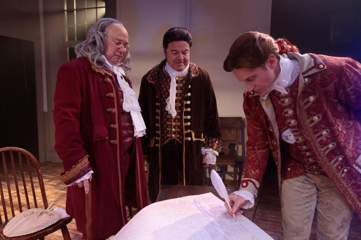 Brian Smith as Benjamin Franklin, Dr. Jeffrey D. Hoy as John Adams and Garrett Hinton as Thomas Jefferson signing the Declaration of Independence in a production of the musical, "1776," at Cocoa Village Playhouse last year.