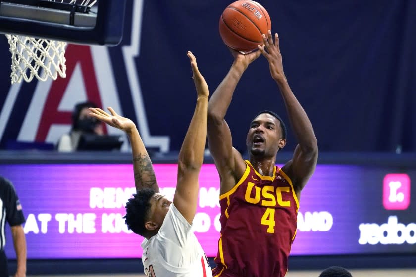 Southern California forward Evan Mobley (4) shoots over Arizona forward Ira Lee during the first half of an NCAA college basketball game Thursday, Jan. 7, 2021, in Tucson, Ariz. (AP Photo/Rick Scuteri)