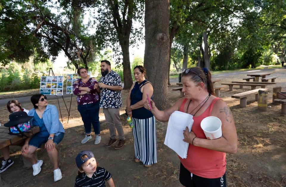 Airport district resident Gwenda Campbell, right, speaks during the Tuolumne River Regional Park master plan update meeting in Mary Grogan Grove in Modesto, Calif., Thursday, June 8, 2023.