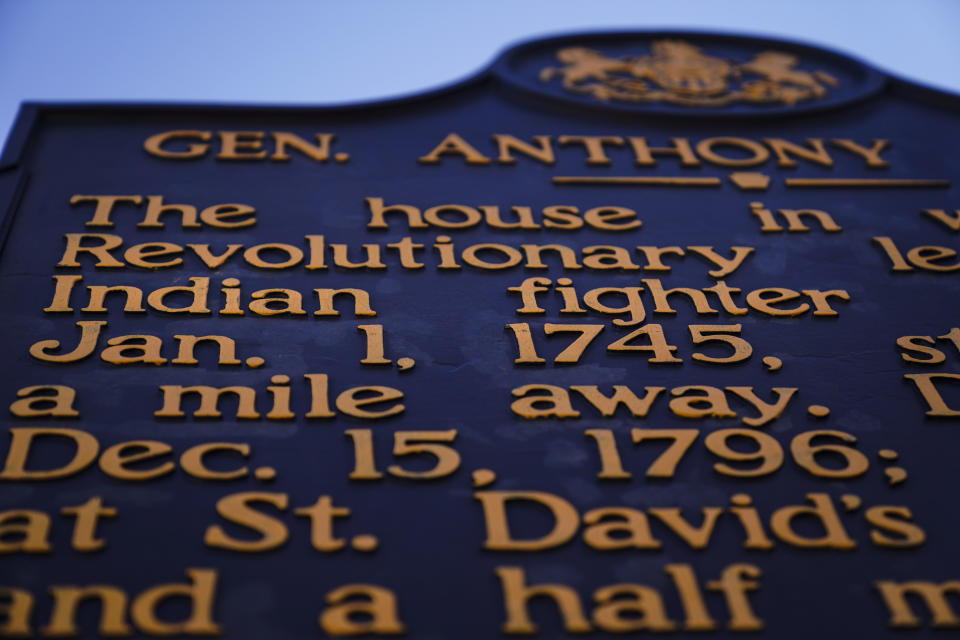 Shown is a Pennsylvania Historical Marker for Revolutionary War Gen. Anthony Wayne in Paoli, Pa., Thursday, Nov. 18, 2021. A recent review of all 2,500 markers the Pennsylvania Historical and Museum Commission had been installing for more than a century, faced a fresh round of questions about just whose stories were being told on the state's roadsides, and the language used to tell them. The increased scrutiny that has focused on factual errors, inadequate historical context and racist or otherwise inappropriate references, prompting the state to remove two markers, revise two and order new text for two others so far. The changes have become grist for the political mill. (AP Photo/Matt Rourke)