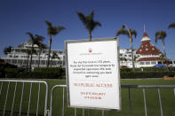 A sign is posted in front of the Hotel Del Coronado Thursday, June 11, 2020, in Coronado, Calif. California's tourism industry is gearing back up with the state giving counties the green light to allow hotels, zoos, aquariums, wine tasting rooms and museums to reopen Friday. (AP Photo/Gregory Bull)