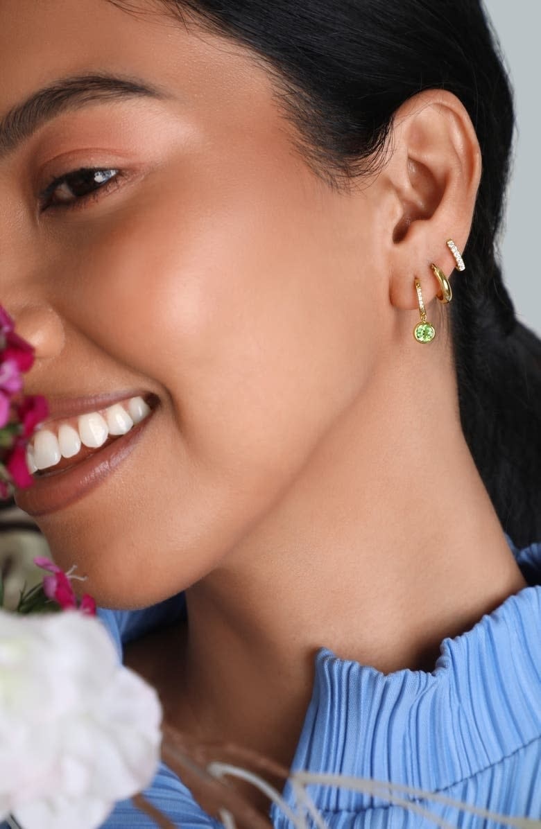 model wearing small huggie 14K gold hoop earrings