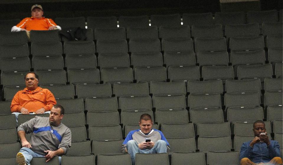 People sit in the stands during the first half of an NCAA college basketball game in the quarterfinal round of the Southeastern Conference tournament, Friday, March 14, 2014, in Atlanta. (AP Photo/John Bazemore)