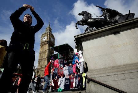 A man takes a picture near the Big Ben clock tower in London, Britain June 29, 2016. REUTERS/Kevin Coombs