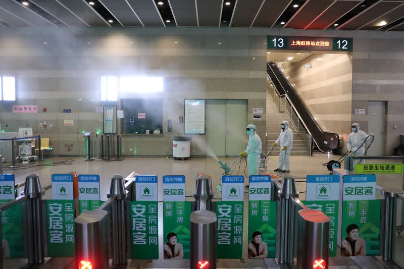 Workers in protective suits disinfect the Shanghai Hongqiao Railway Station, following the outbreak of a new coronavirus, in Shanghai